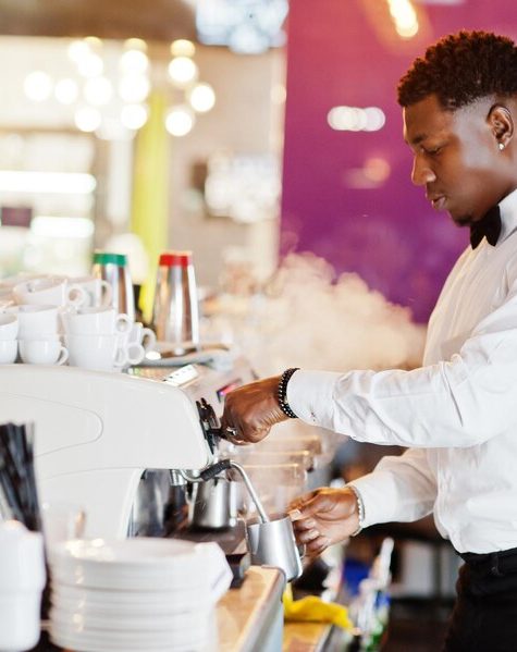 african-american-bartender-barista-bar-preparing-coffee_627829-13178